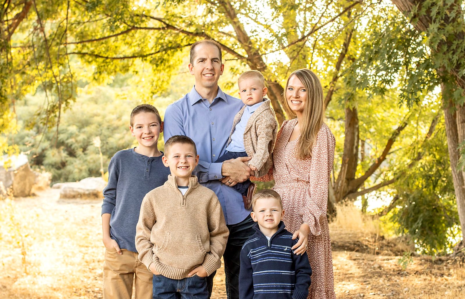 Dr. Keven Freeman with his wife, Amy, and their sons under fall trees